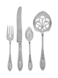 Gadroonette pattern with an engraved monogram, comprising: 12 dinner knives 12 dinner forks 12 salad forks 12 cocktail forks 12 teaspoons 12 soup spoons 12 iced tea spoons 12 citrus spoons 12 butter spreaders 3 table spoons 2 sugar scoops 1 cold meat fork 1 tomato server 1 sauce ladle 1 cake slice 1 poultry shears 1 two-piece carving set 120 items total.