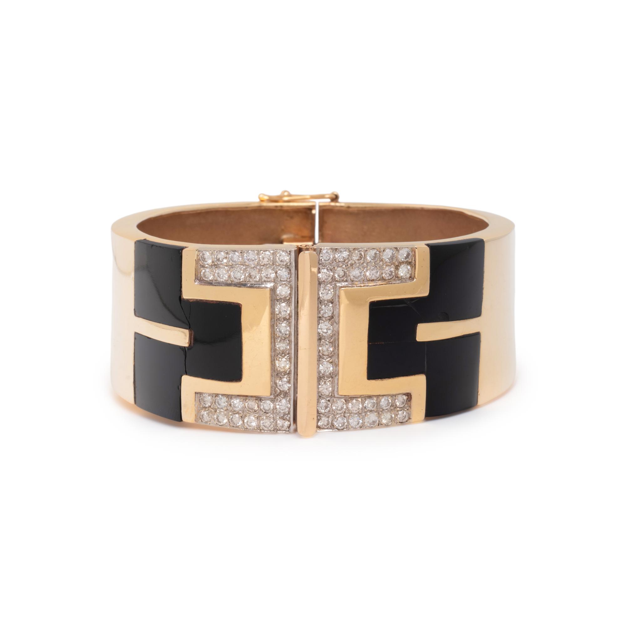 YELLOW GOLD, ONYX, AND DIAMOND HINGED BANGLE BRACELET