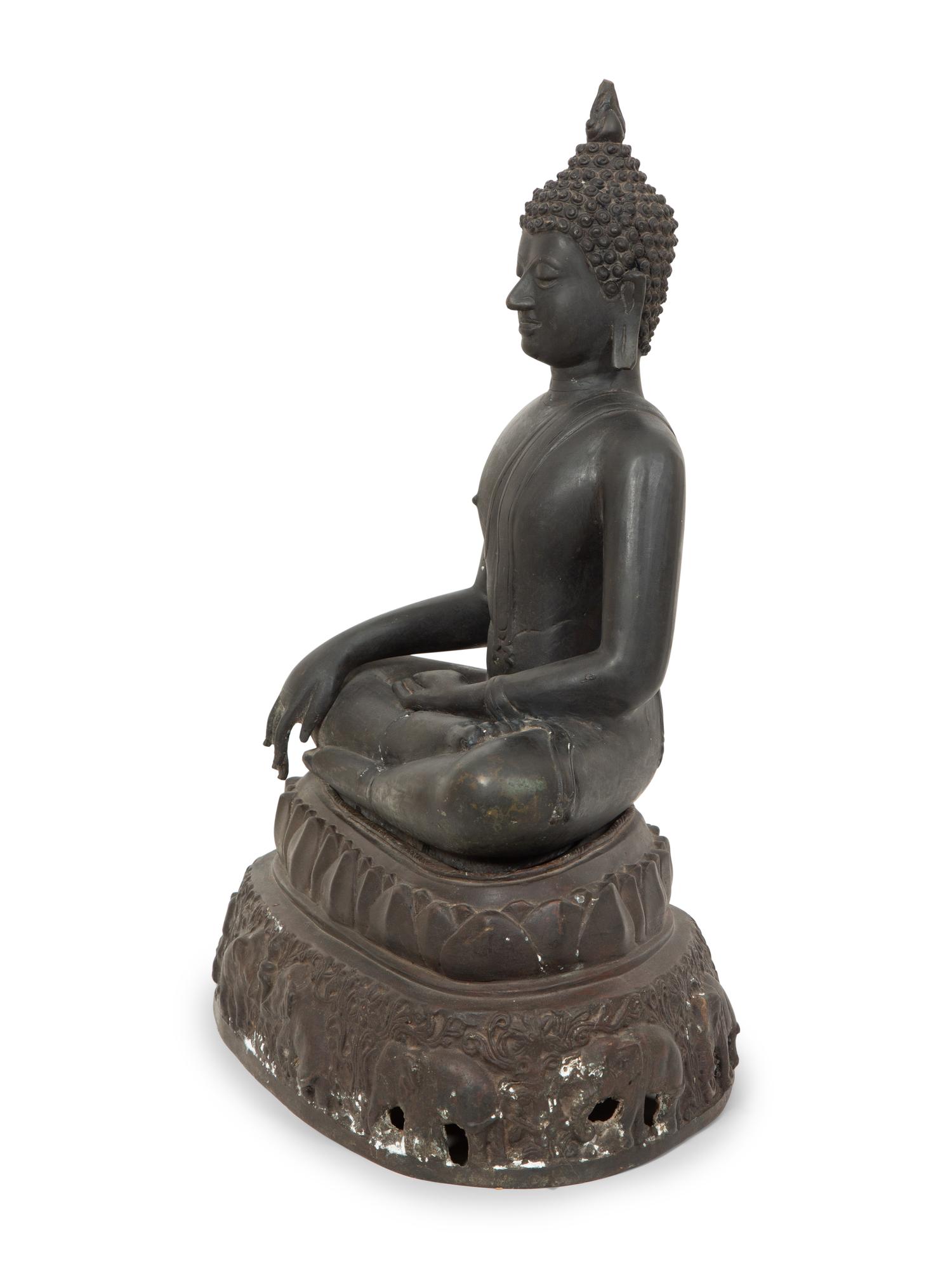 A Cambodian Bronze Figure of Seated Deity on Conforming Base