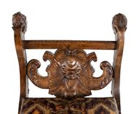 An Italian Renaissance Revival Carved Walnut Curule Bench
