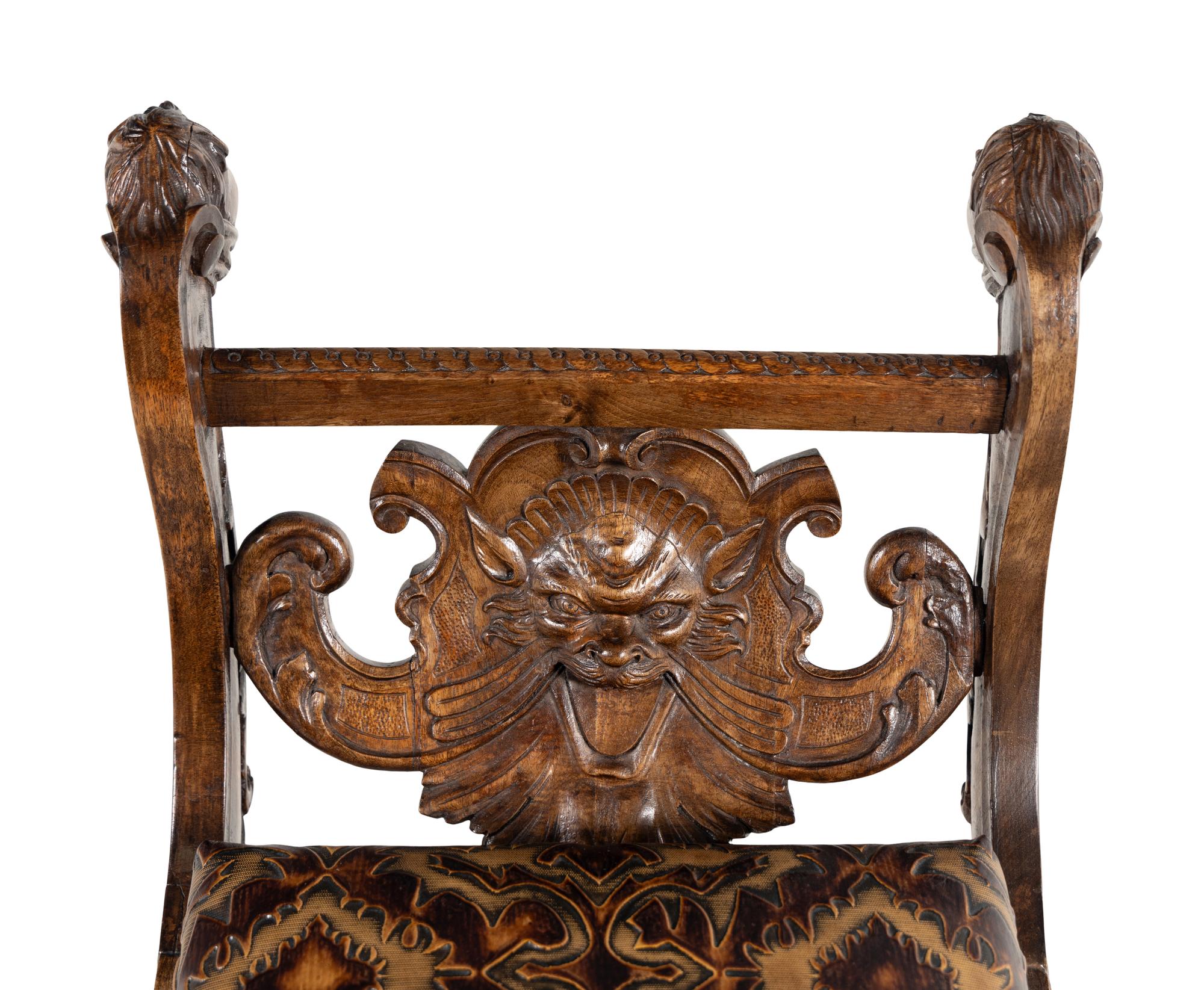 An Italian Renaissance Revival Carved Walnut Curule Bench