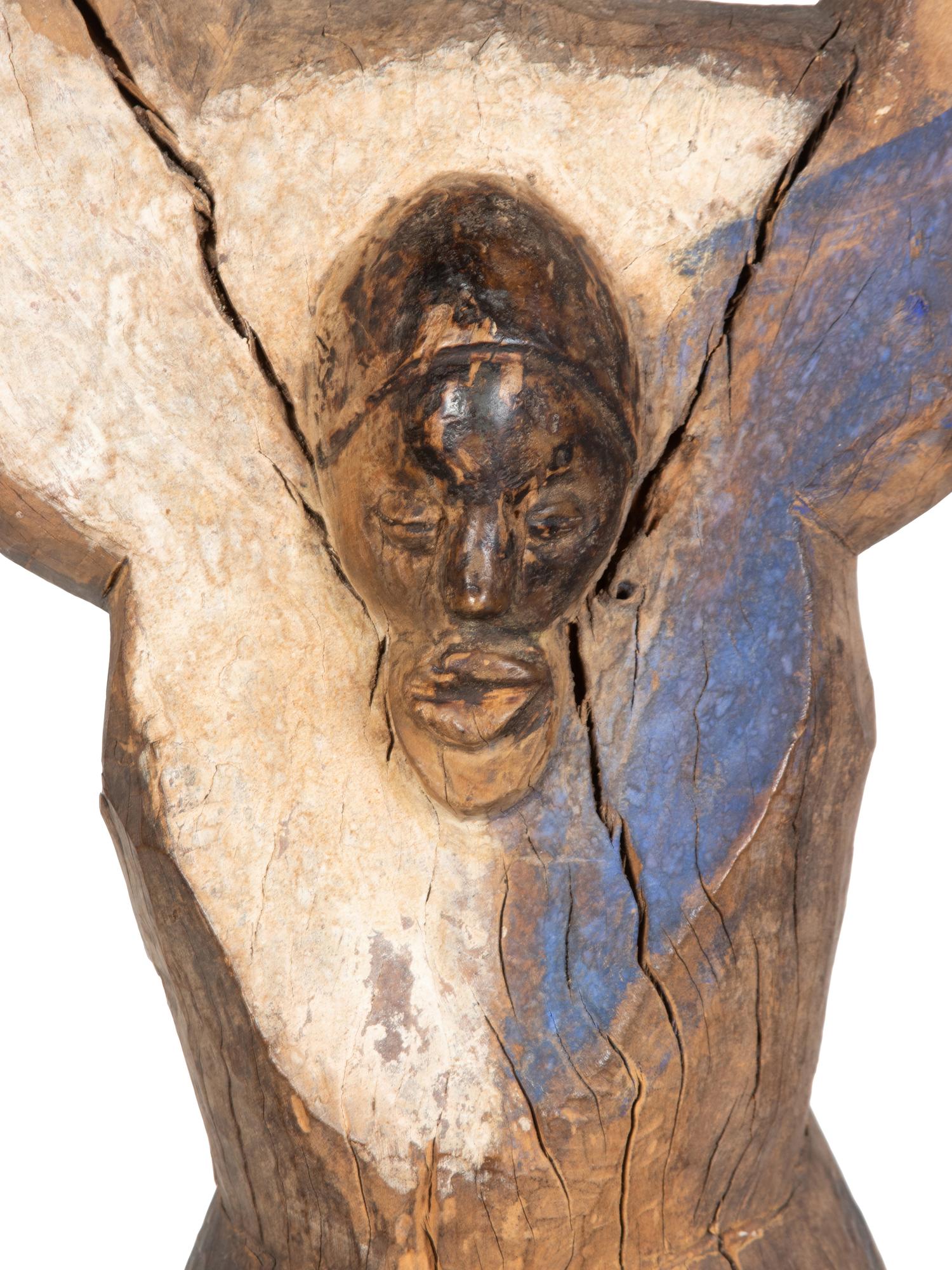 A Yaka Post, with forked finial painted blue and white, a mask in relief at the center