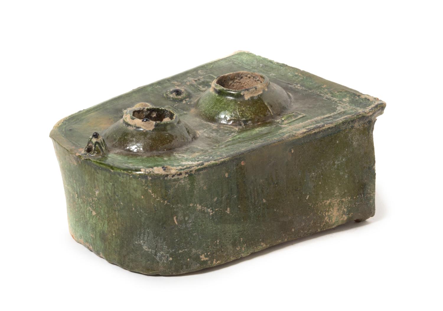A Chinese Dark Green Glazed Pottery Model of a Stove Length 9 x width 6 3/4 inches. — HAN DYNASTY (206 B.C. - A.D. 220)