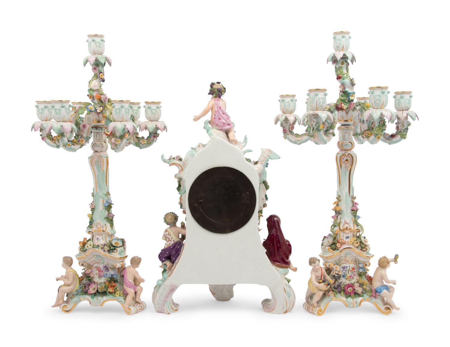 A Meissen Porcelain Clock Garniture and Clock Stand