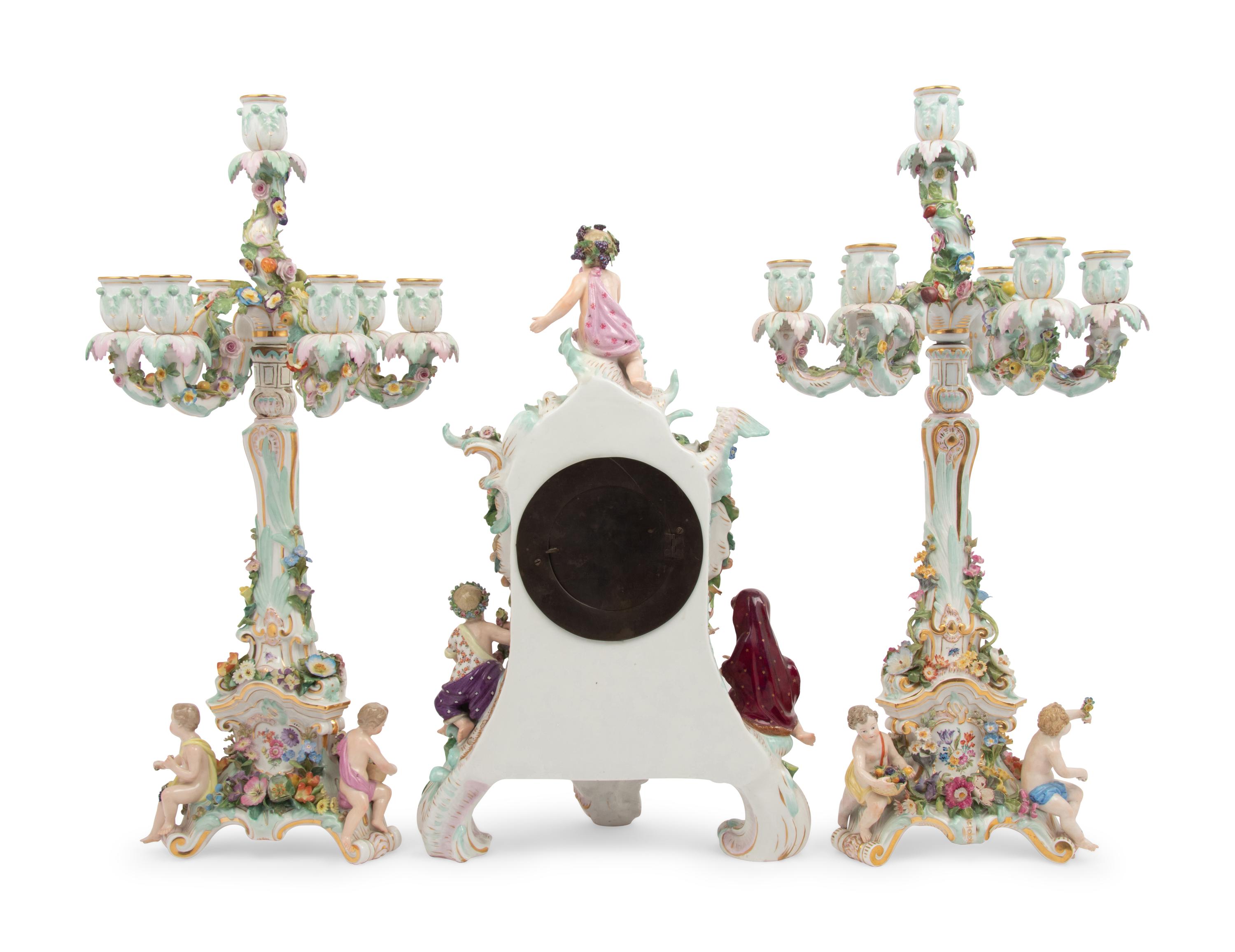 A Meissen Porcelain Clock Garniture and Clock Stand