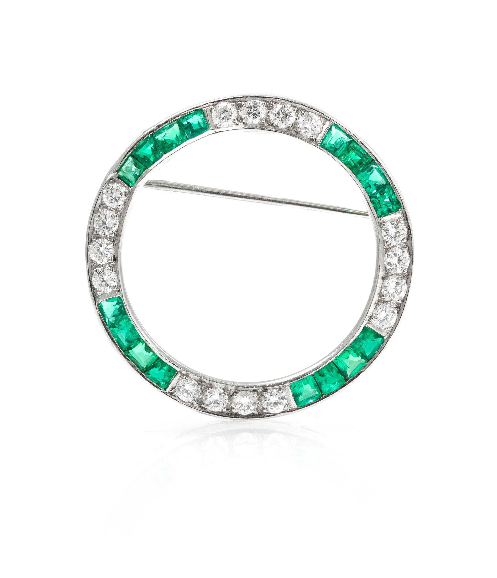A Platinum, Diamond, and Emerald Circle Brooch, 4.40 dwts.