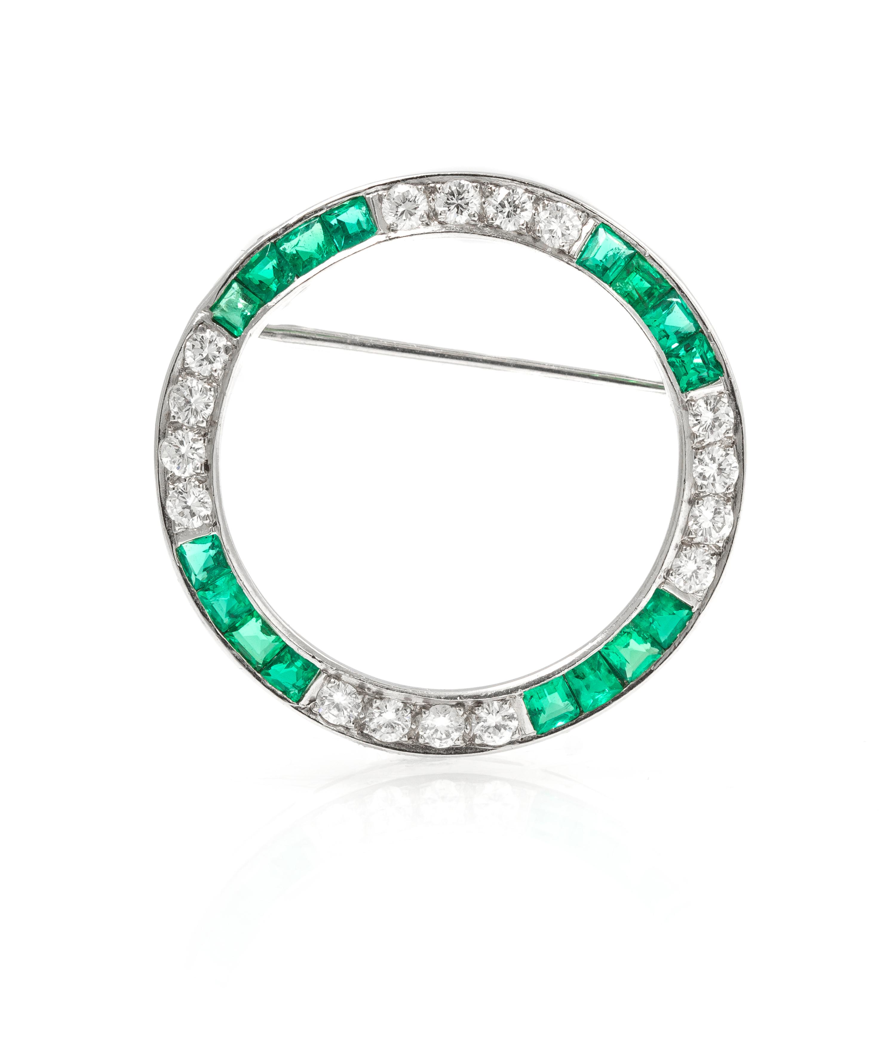 A Platinum, Diamond, and Emerald Circle Brooch, 4.40 dwts.