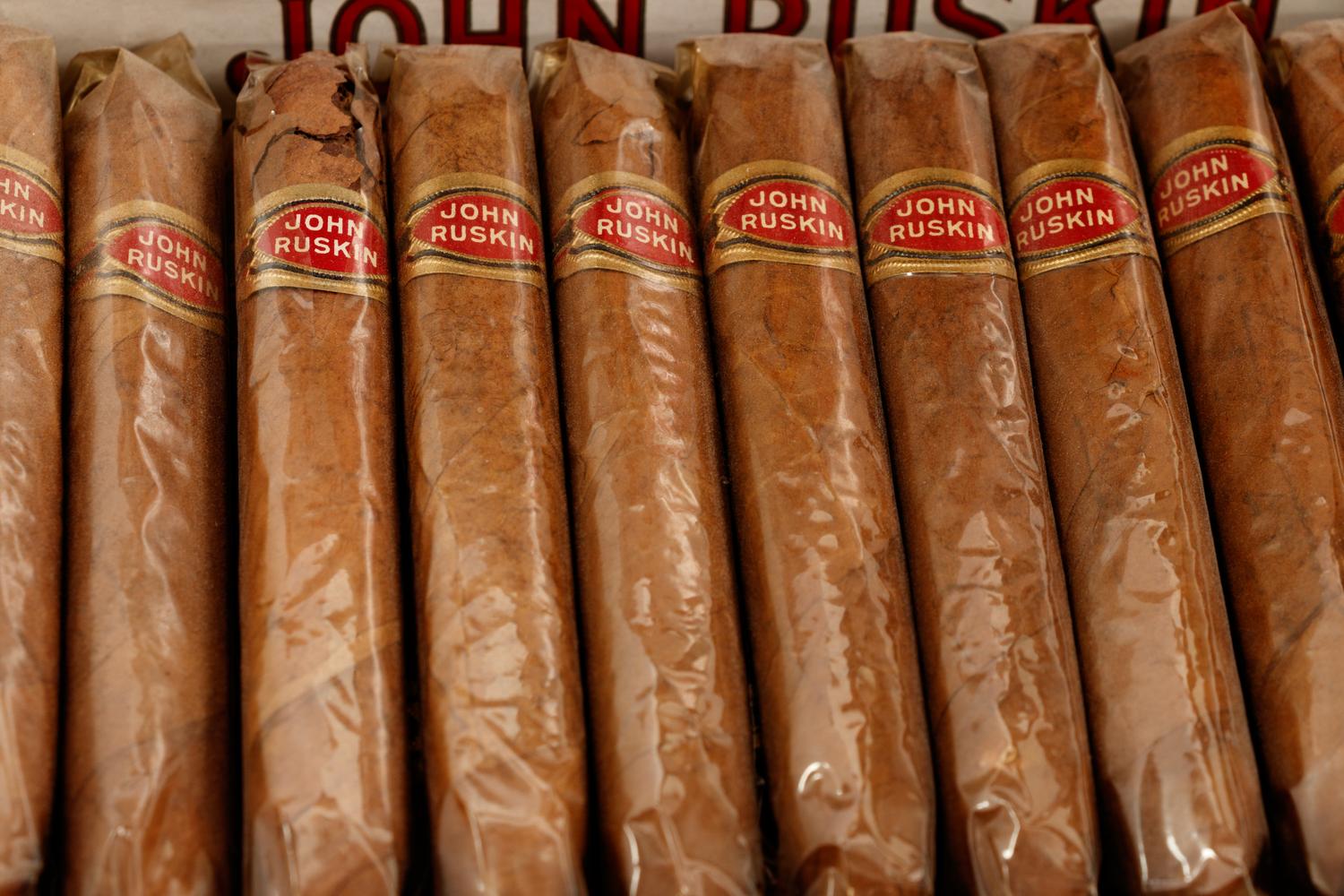 A Collection of Fifteen Tobacco Cartons and a Tobacco Rope in Display Case