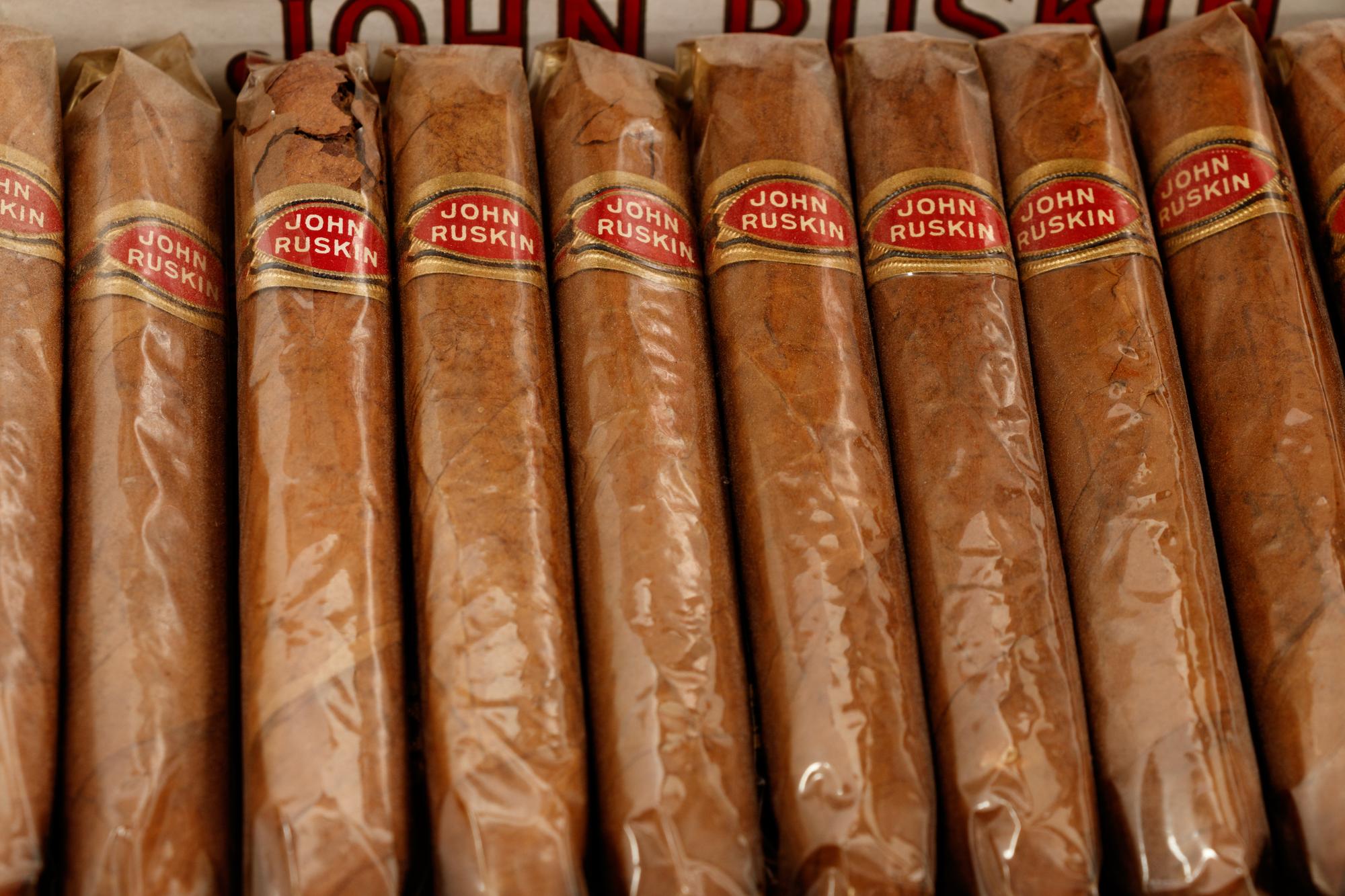 A Collection of Fifteen Tobacco Cartons and a Tobacco Rope in Display Case
