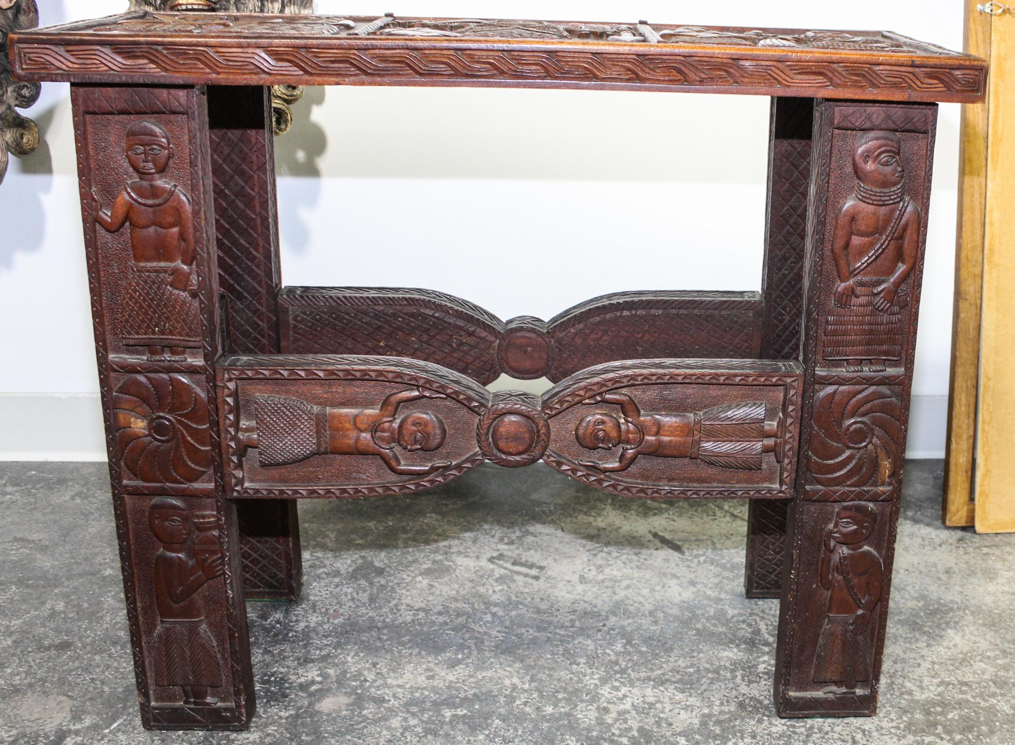 An Ethnographic Side Table. Height 26 1/4 x width 31 x depth 11 3/4 inches.