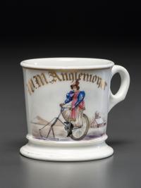 A Porcelain Shaving Mug Depicting a Woman Riding an Ice Velocipede