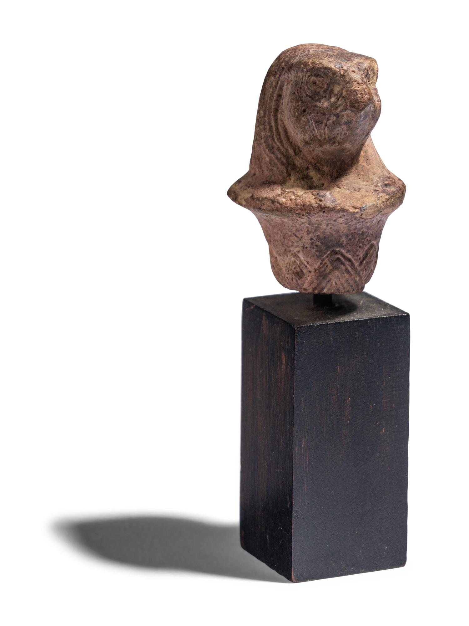 An Egyptian Stone Wadj Fragment with the Head of a Falcon