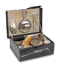 A Cased Gorham Silver Eighteen-Piece Travel Dresser Set Retailed by Cartier
