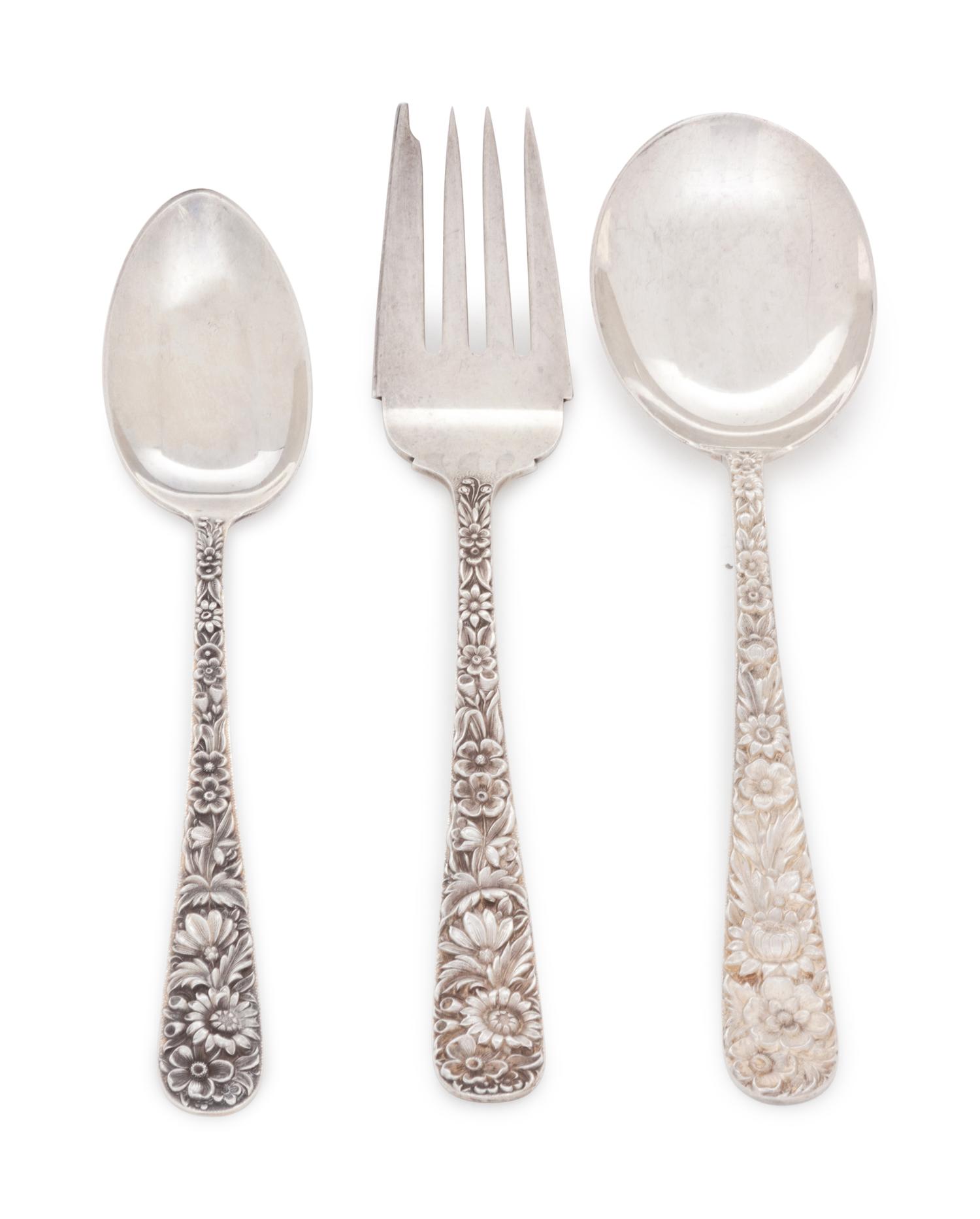 in the Repousse pattern, comprising: 4 dinner knives with blunt stainless steel blades 10 dinner knives with stainless steel blades 1 steak knife with stainless steel blade 1 cake server with stainless steel blade 15 iced tea spoons 3 tablespoons 8 soup spoons 1 ladle 7 butter spreaders 3 cocktail forks 4 demitasse spoons 8 salad forks 8 dinner forks 22 teaspoons 95 pieces total.