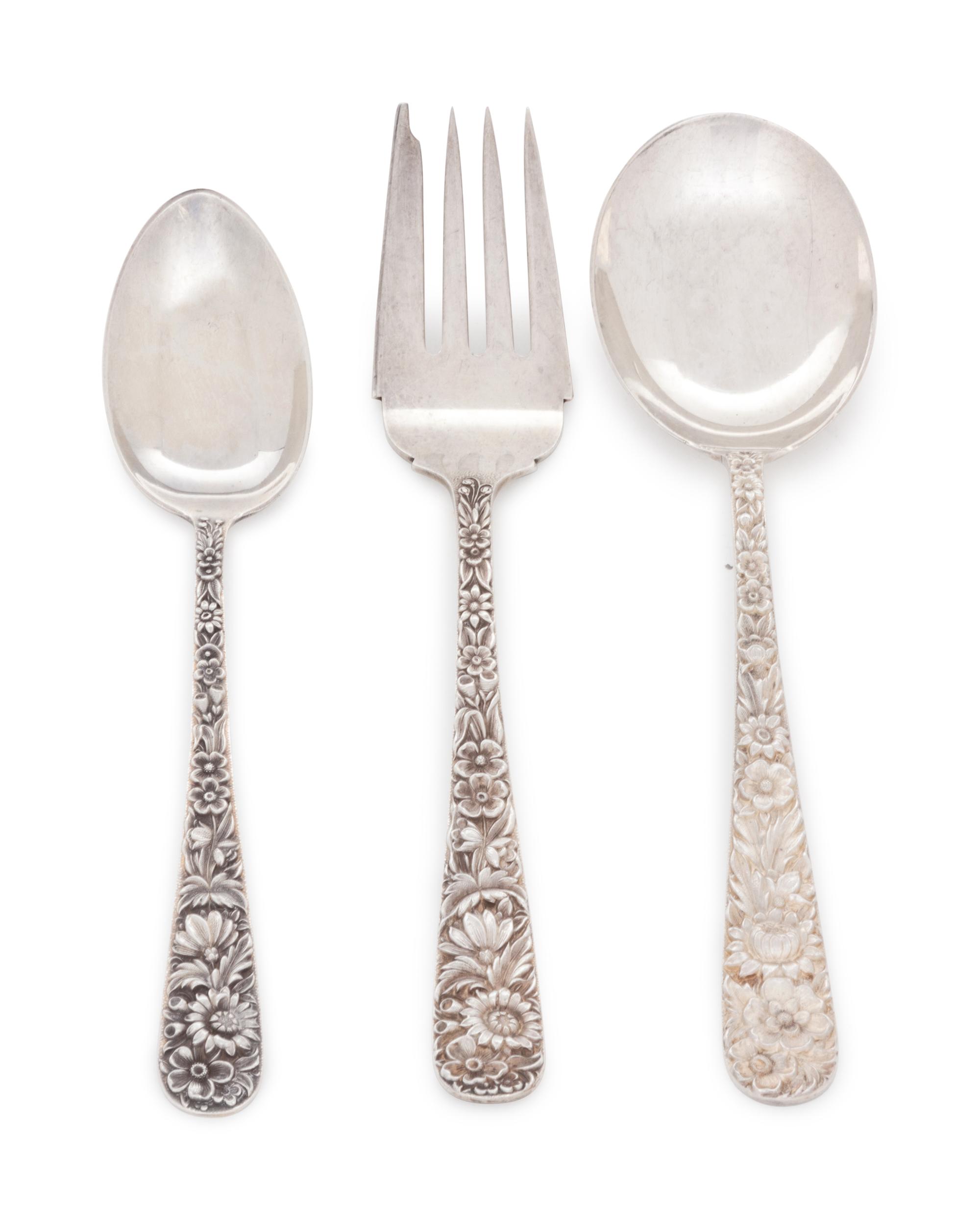 in the Repousse pattern, comprising: 4 dinner knives with blunt stainless steel blades 10 dinner knives with stainless steel blades 1 steak knife with stainless steel blade 1 cake server with stainless steel blade 15 iced tea spoons 3 tablespoons 8 soup spoons 1 ladle 7 butter spreaders 3 cocktail forks 4 demitasse spoons 8 salad forks 8 dinner forks 22 teaspoons 95 pieces total.