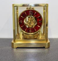 A Swiss Brass Atmos Clock. Height 9 3/4 inches.