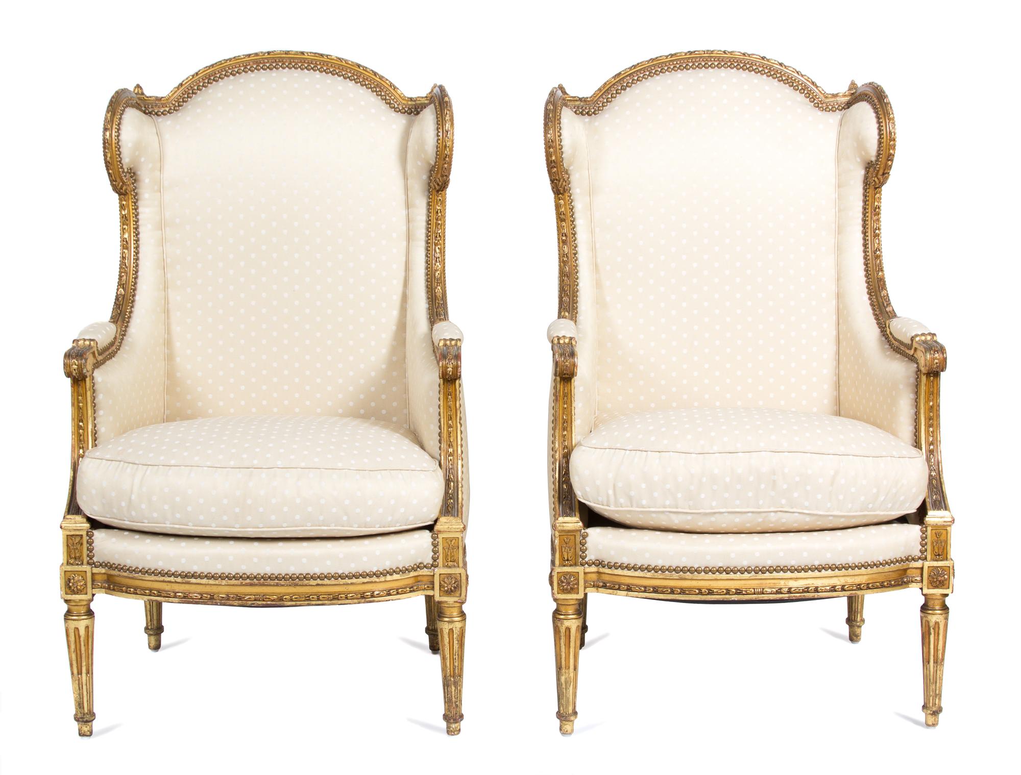 A Pair of Louis XVI Style Giltwood Wing Back Chairs Height 43 1/2 x width 26 1/2 x depth 24 inches. — 19TH CENTURY