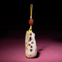 A Chinese Russet and White Jade Reticulated 'Lotus' Pendant, 18th/19th Century — 清中期 白玉帶皮鏤雕蓮紋佩