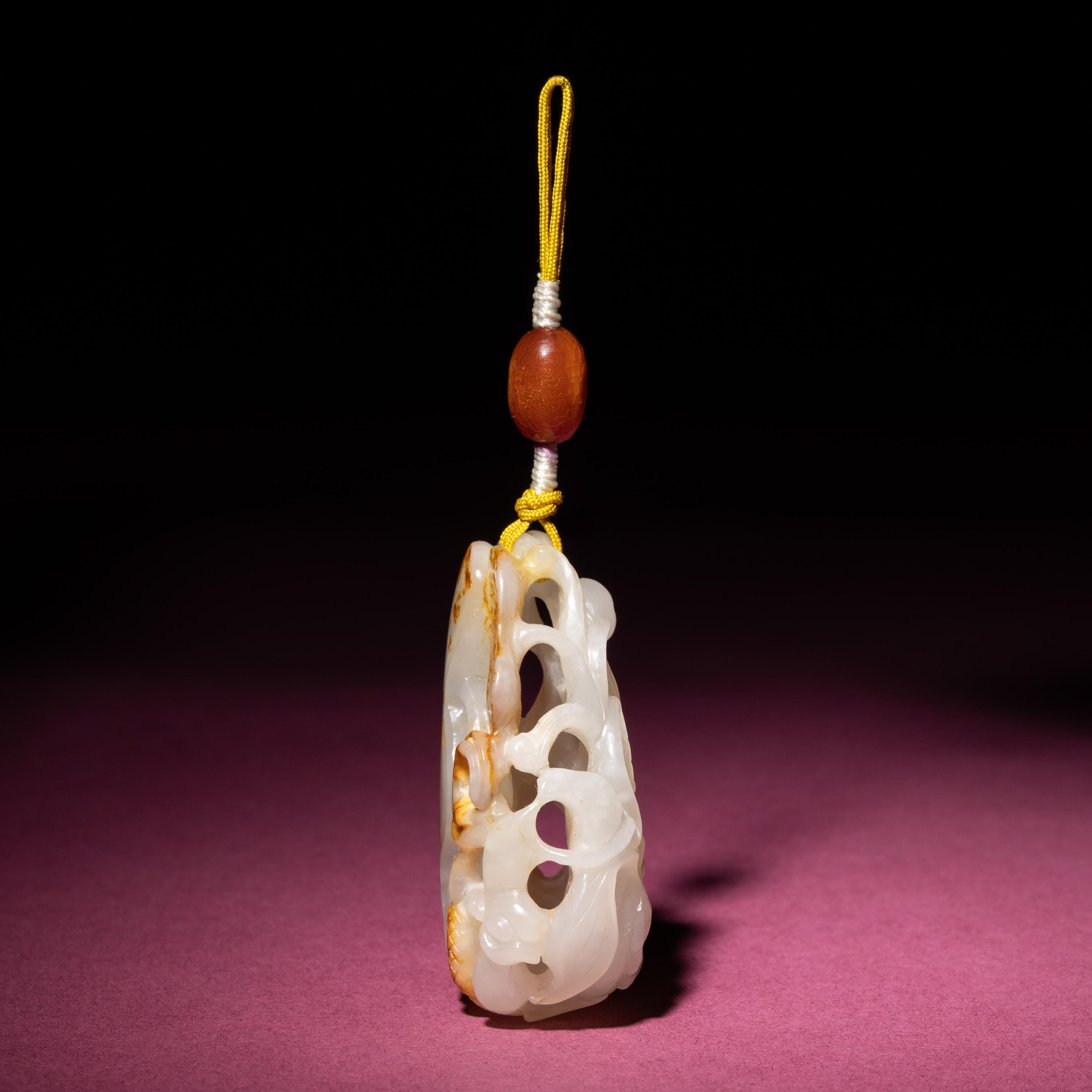 A Chinese Russet and White Jade Reticulated 'Lotus' Pendant, 18th/19th Century — 清中期 白玉帶皮鏤雕蓮紋佩