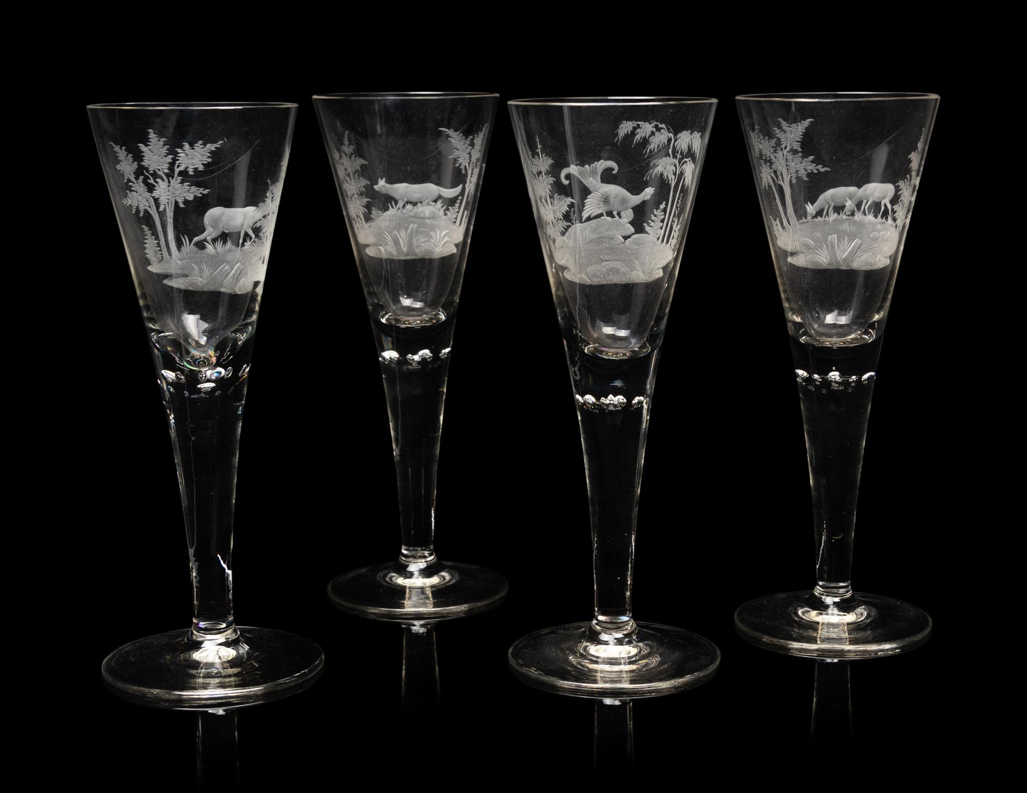 A Set of Four Large Etched Glass Wine Stems