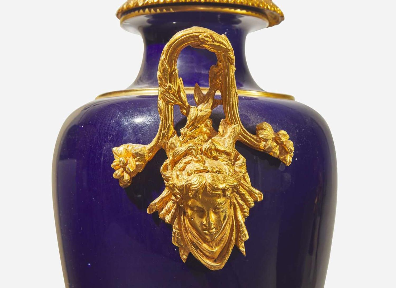 A pair of French gilt bronze mounted cobalt blue porcelain urns, late 19th / early 20th century
