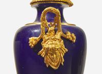 A pair of French gilt bronze mounted cobalt blue porcelain urns, late 19th / early 20th century