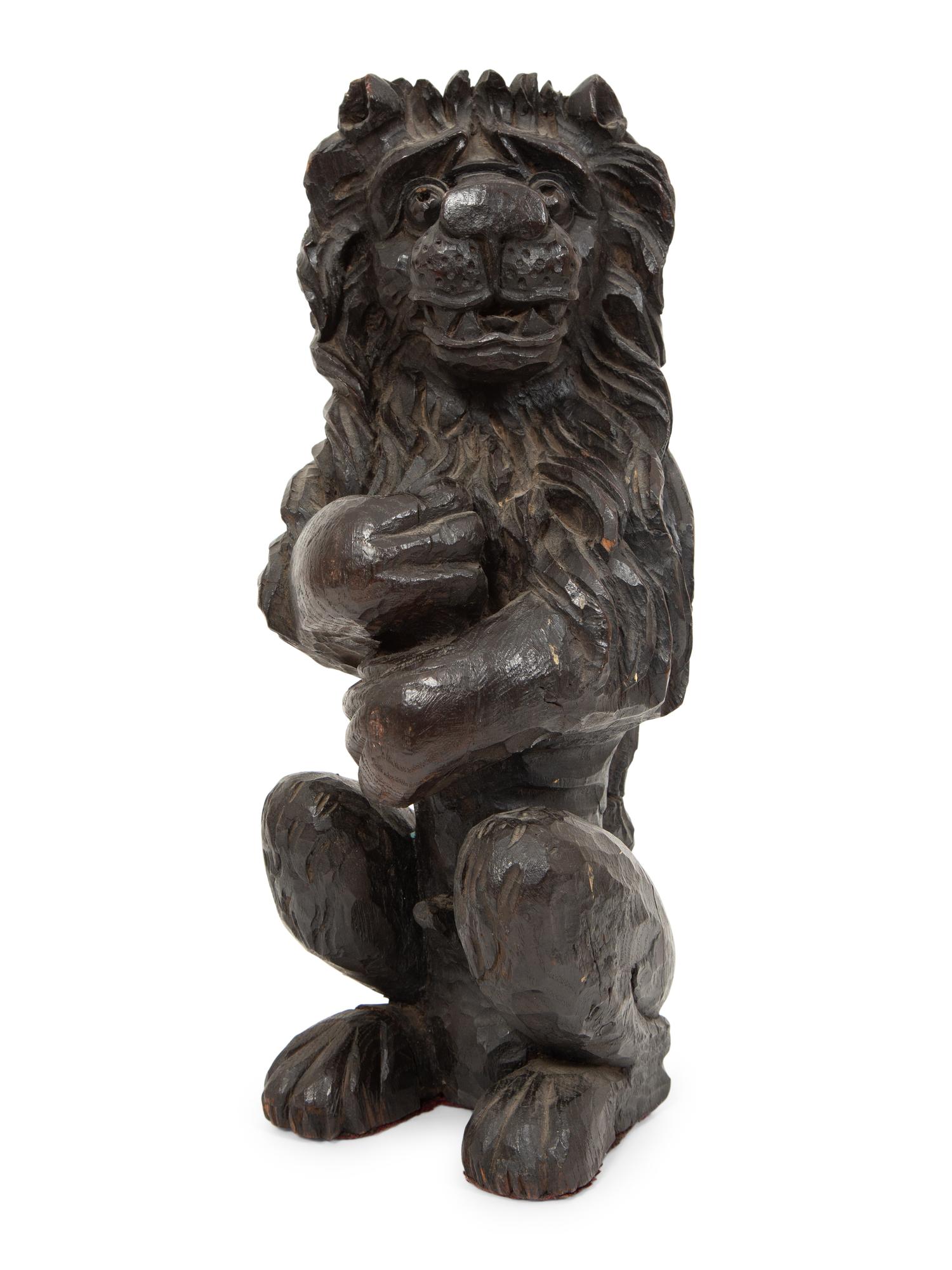 An English Carved and Stained Oak Figure of a Lion
