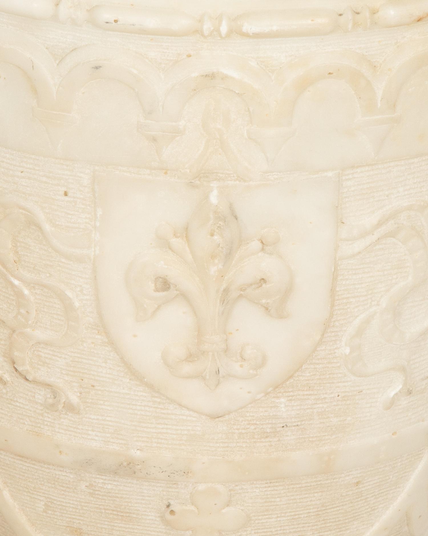 An Italian Carved Marble Urn with Griffin Handles