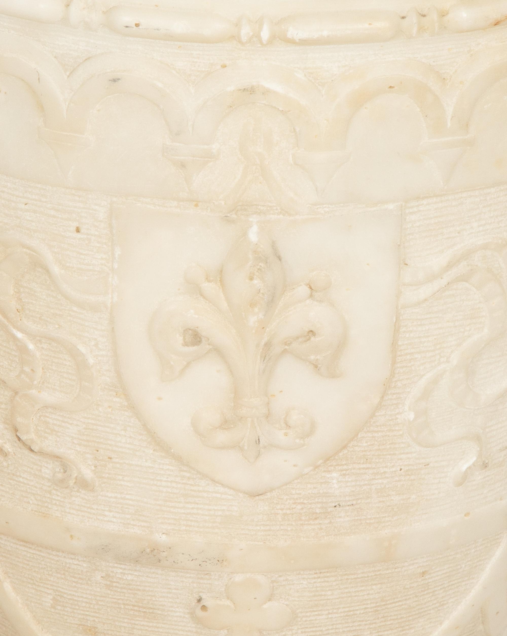 An Italian Carved Marble Urn with Griffin Handles