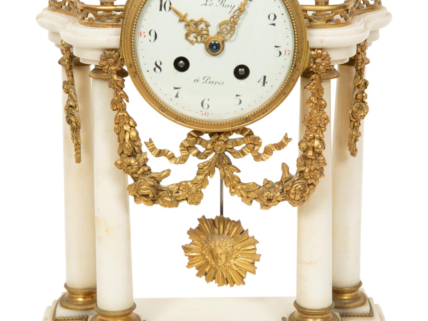 An Empire Style Gilt Bronze Mounted Marble Portico Clock
