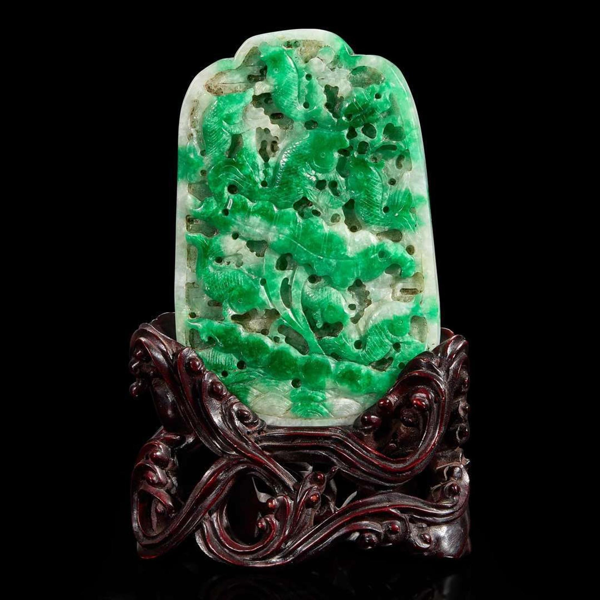A Chinese carved jadeite panel and wood stand