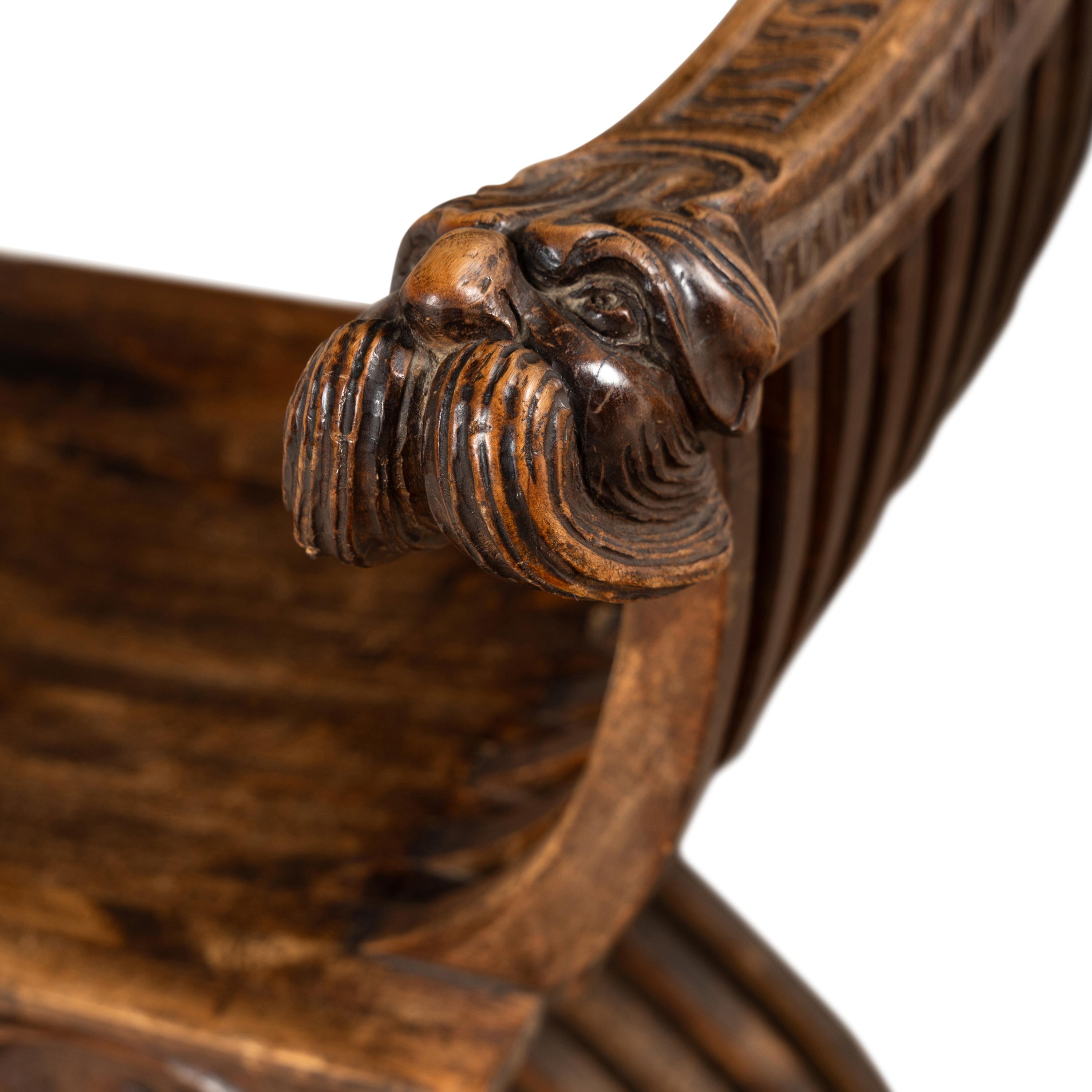 A Pair of Italian Carved Walnut Savonarola Chairs