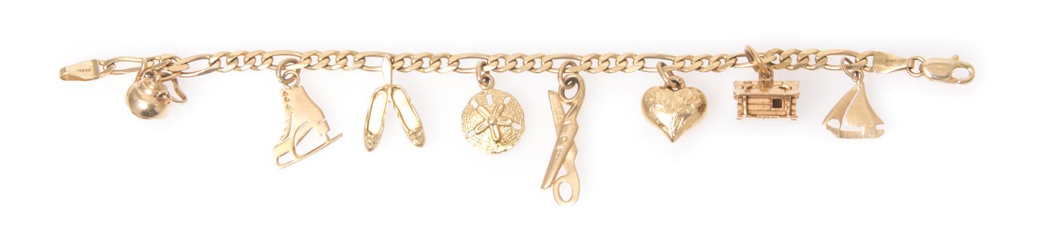 A 14 Karat Yellow Gold Charm Bracelet with 8 Attached Charms, 7.00 dwts.