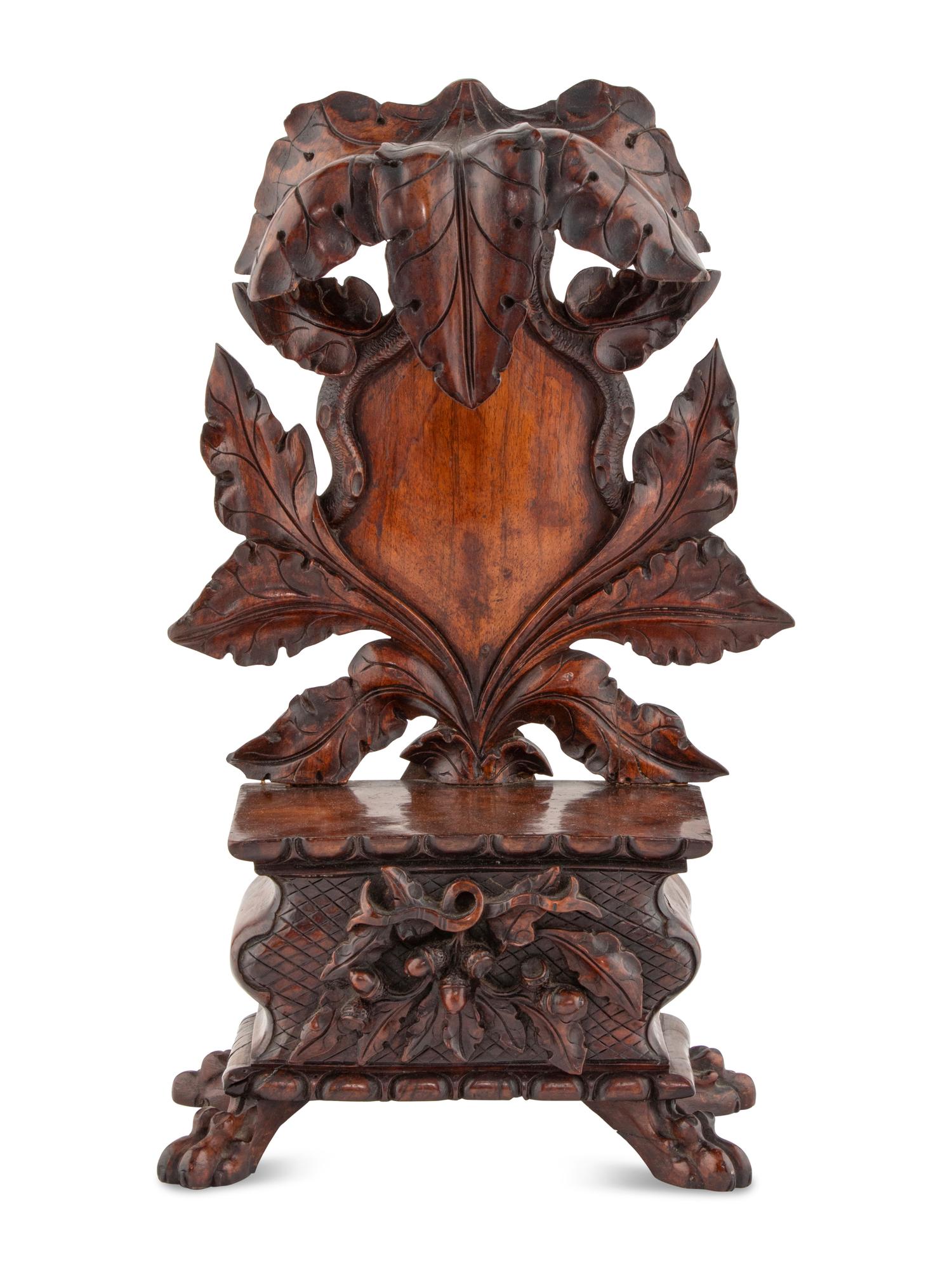 A Black Forest Carved Walnut Stand