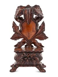 A Black Forest Carved Walnut Stand