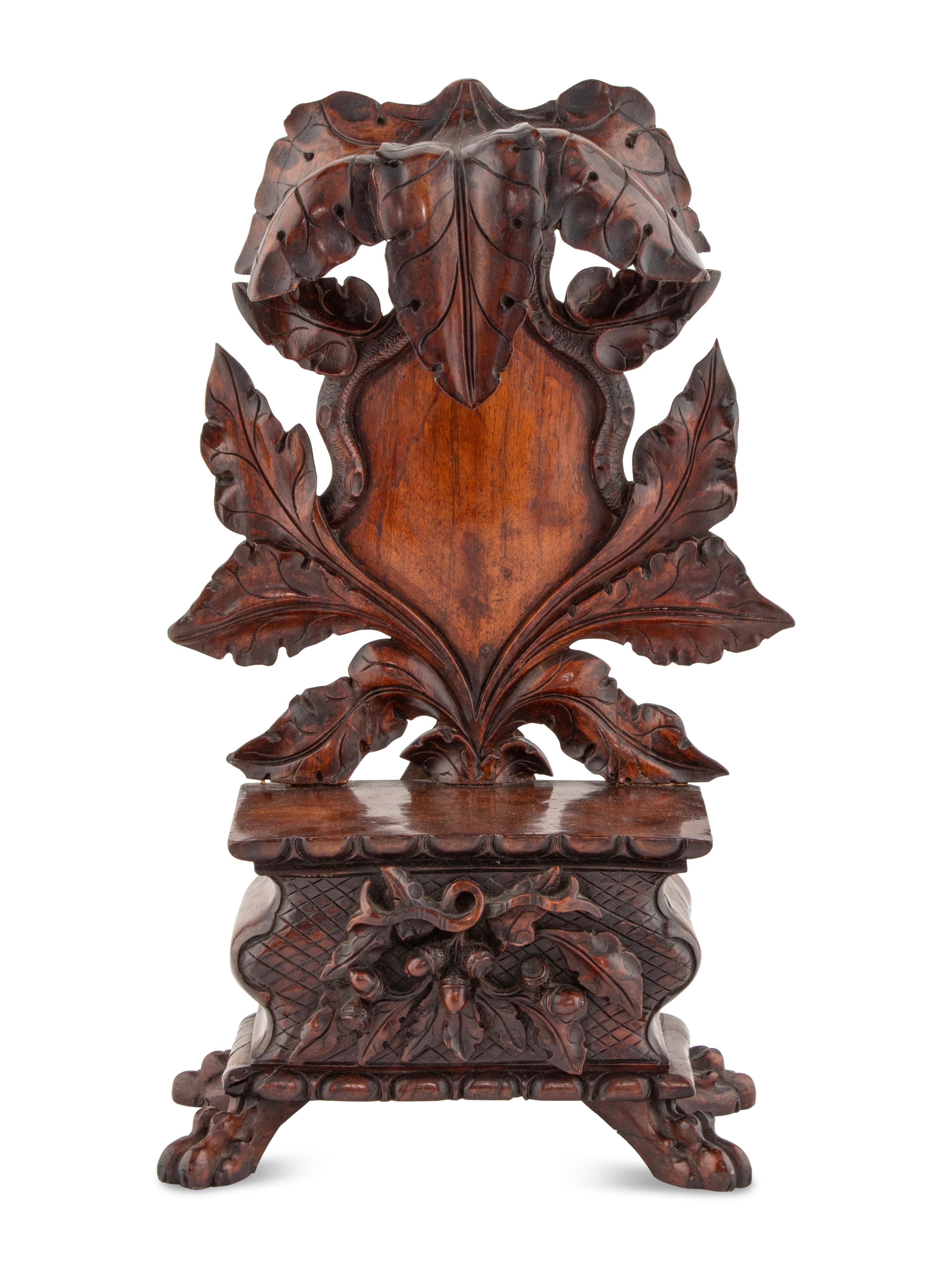 A Black Forest Carved Walnut Stand