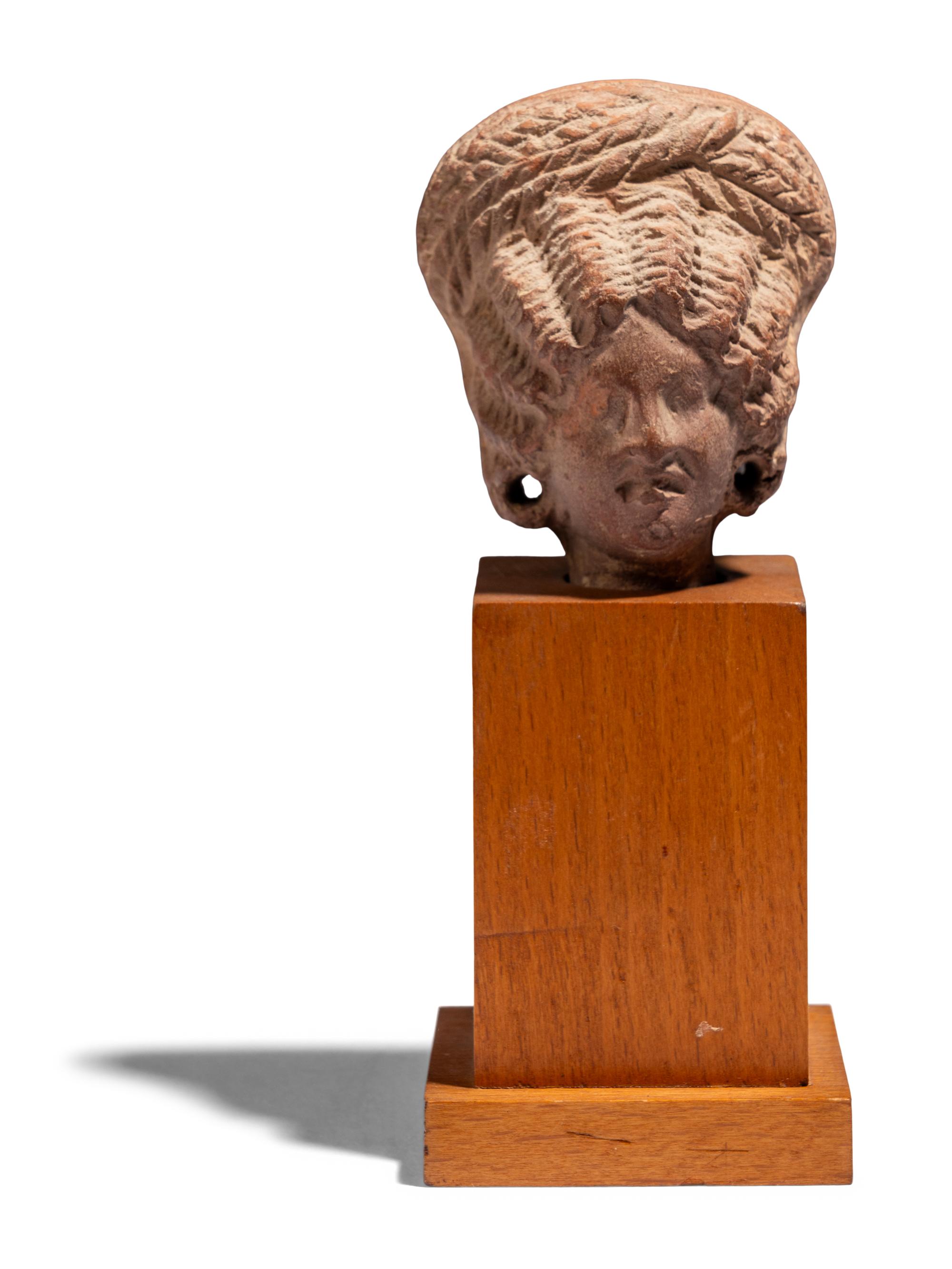 An Egyptian Terracotta Head of a Woman