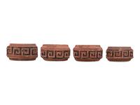 A Set of Four Continental Terra Cotta Ornaments
