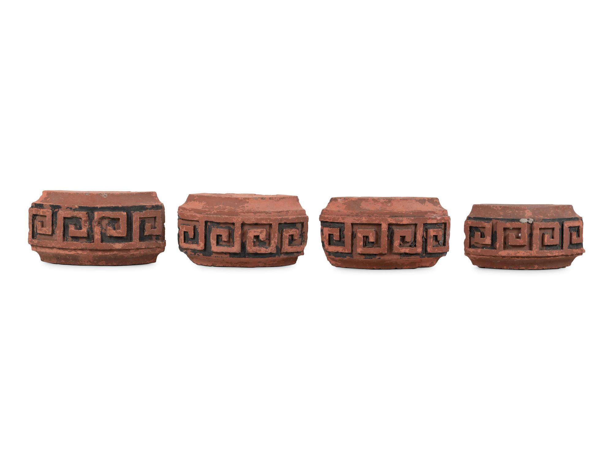 A Set of Four Continental Terra Cotta Ornaments