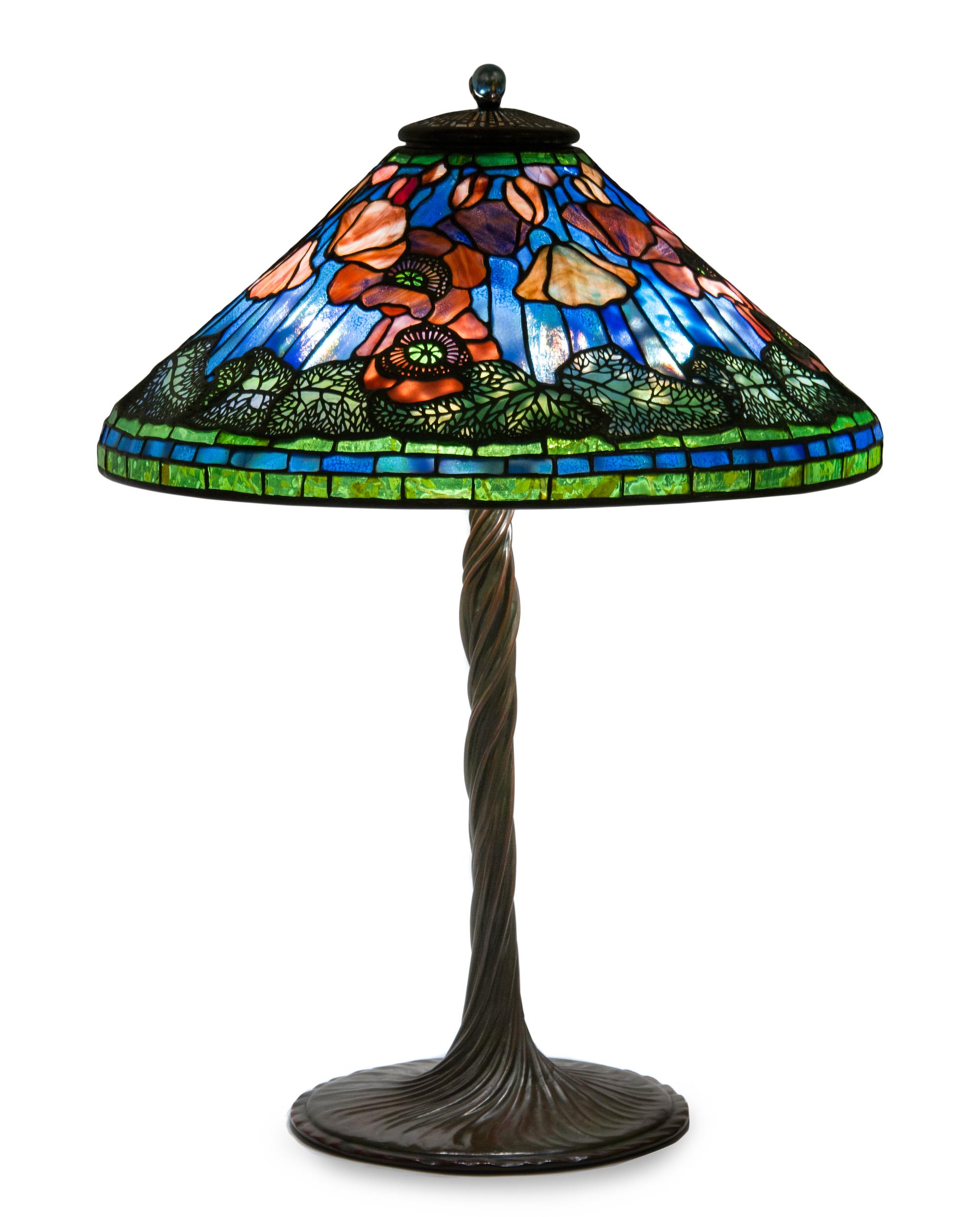A Tiffany Studios Blue Favrile Glass and Bronze Elaborate Poppy Table Lamp Diameter of shade 20 1/4 inches, height overall 27 1/2 inche