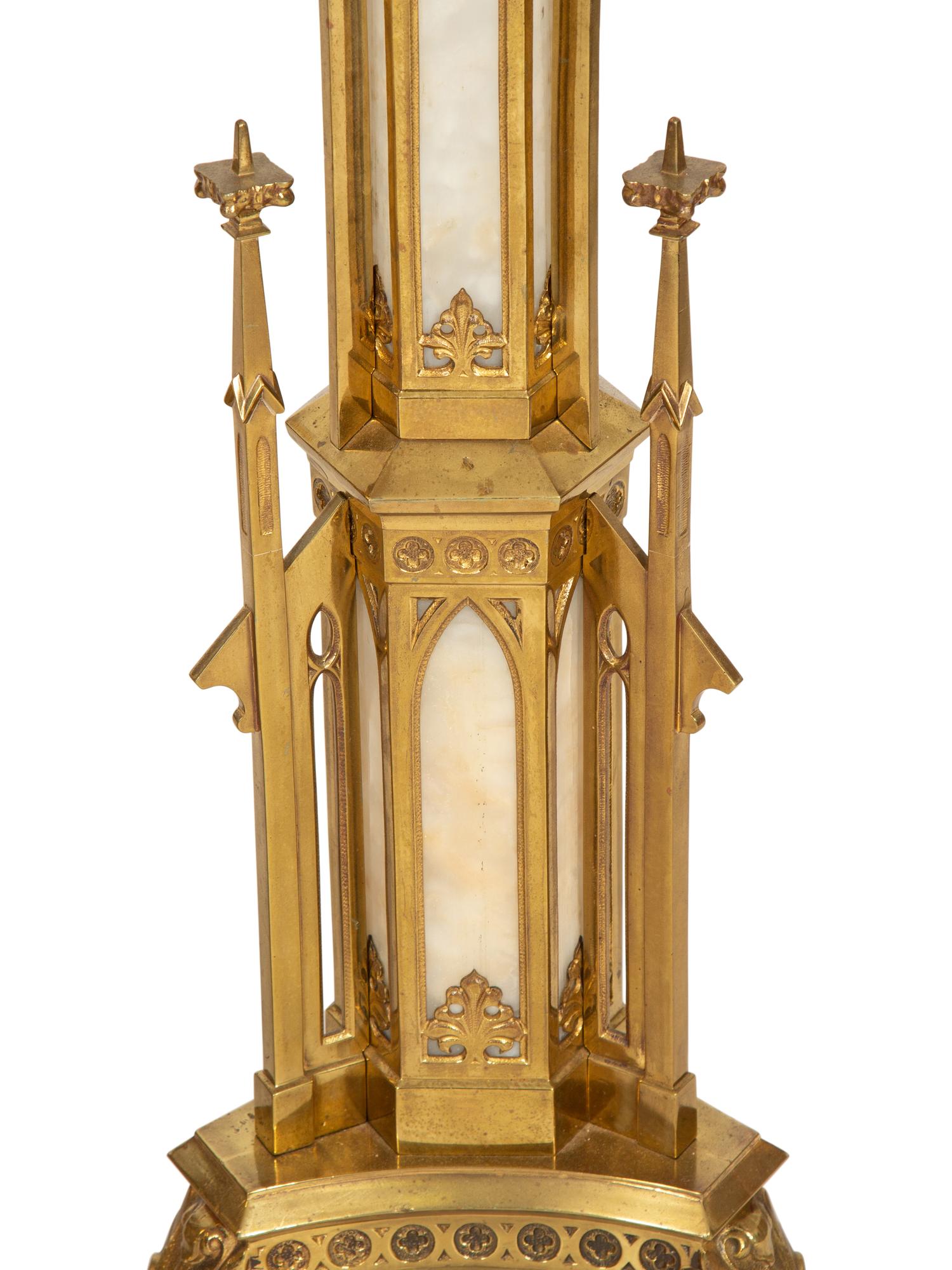 A Pair of Gothic Style Brass and Inset Glass Candlesticks