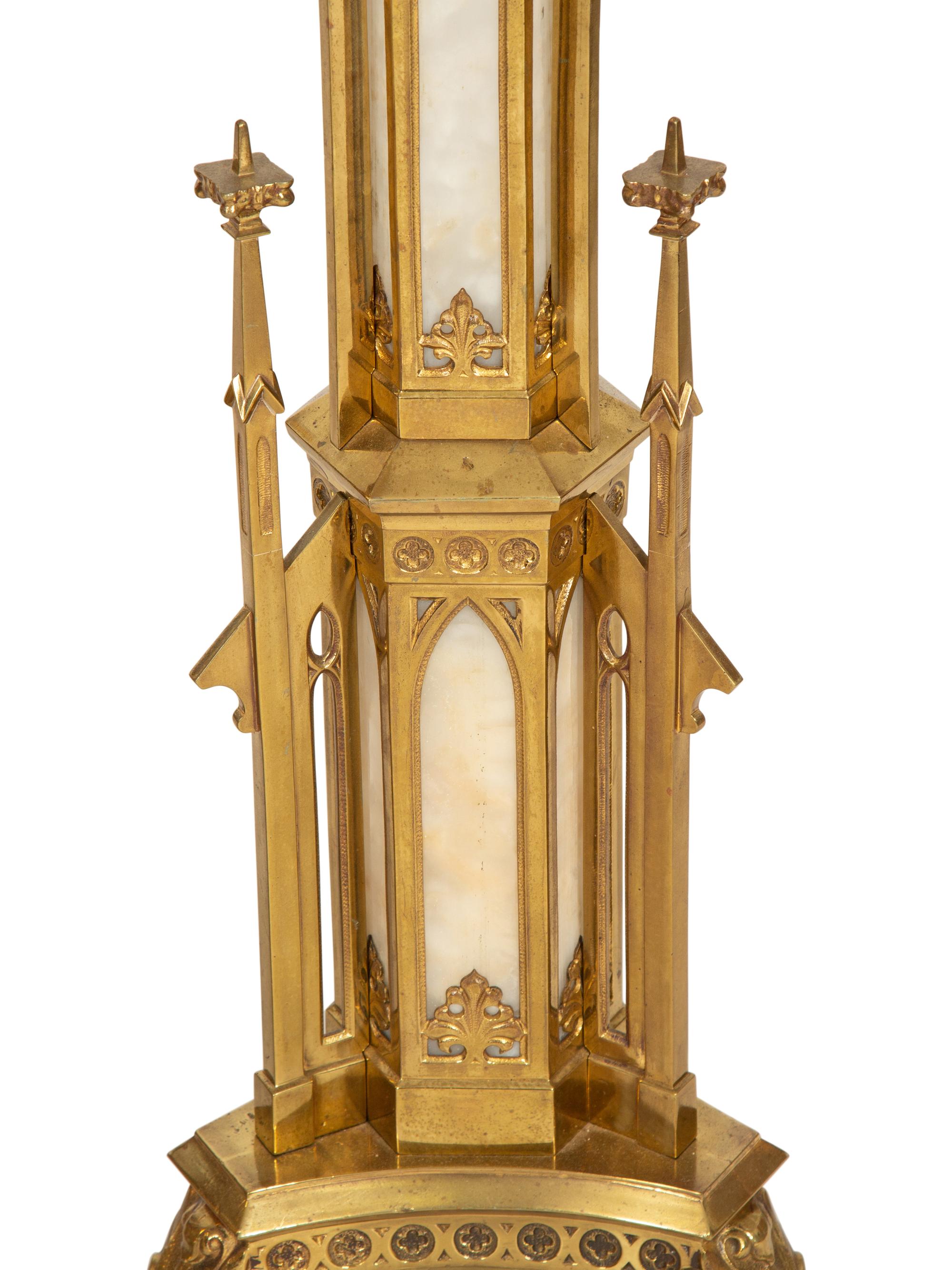 A Pair of Gothic Style Brass and Inset Glass Candlesticks