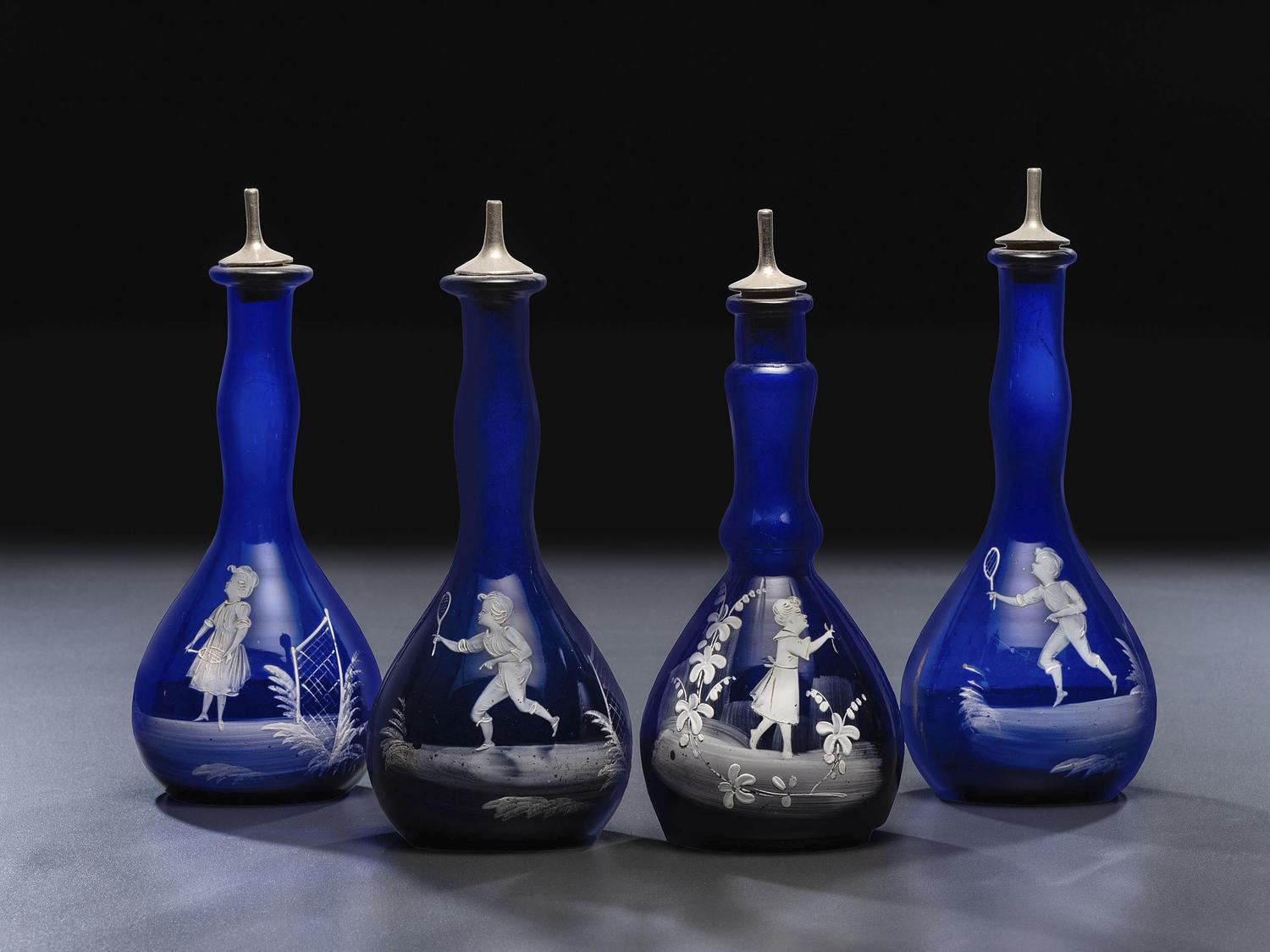 Four 'Mary Gregory' Cobalt Glass Barber Bottles