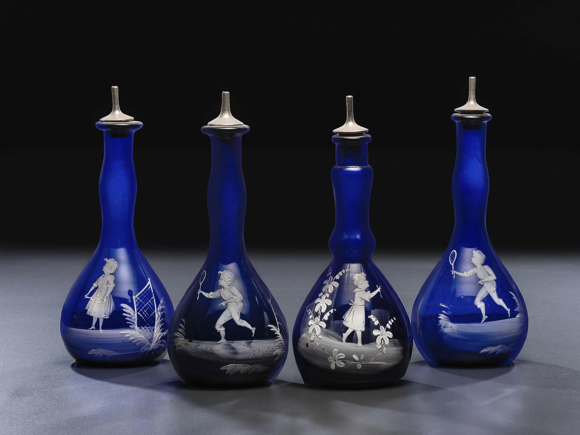 Four 'Mary Gregory' Cobalt Glass Barber Bottles