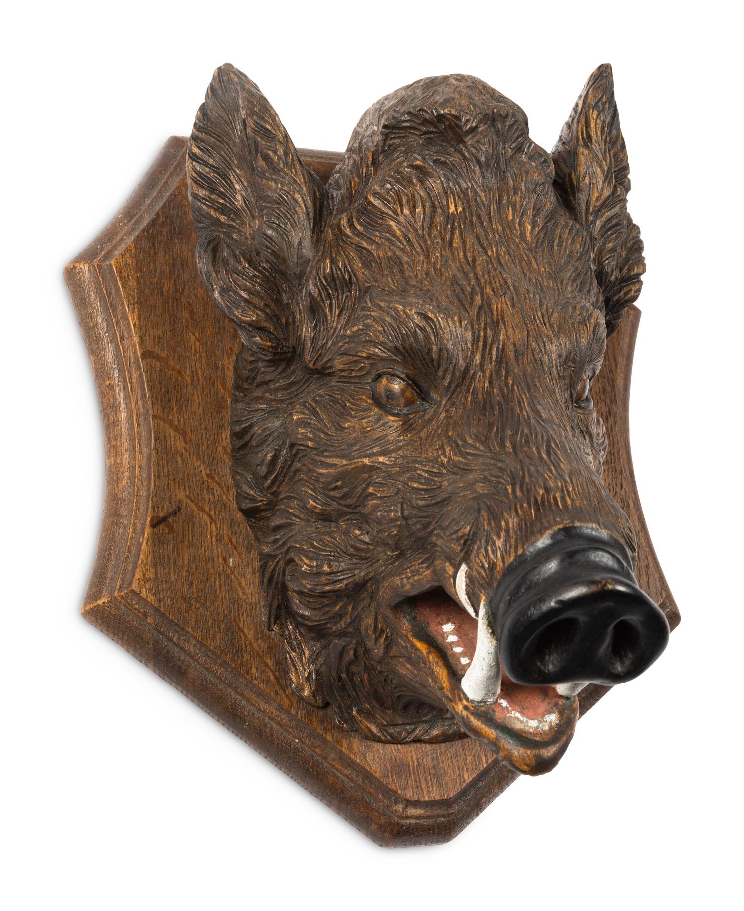 A Black Forest Carved Boar Head Mount