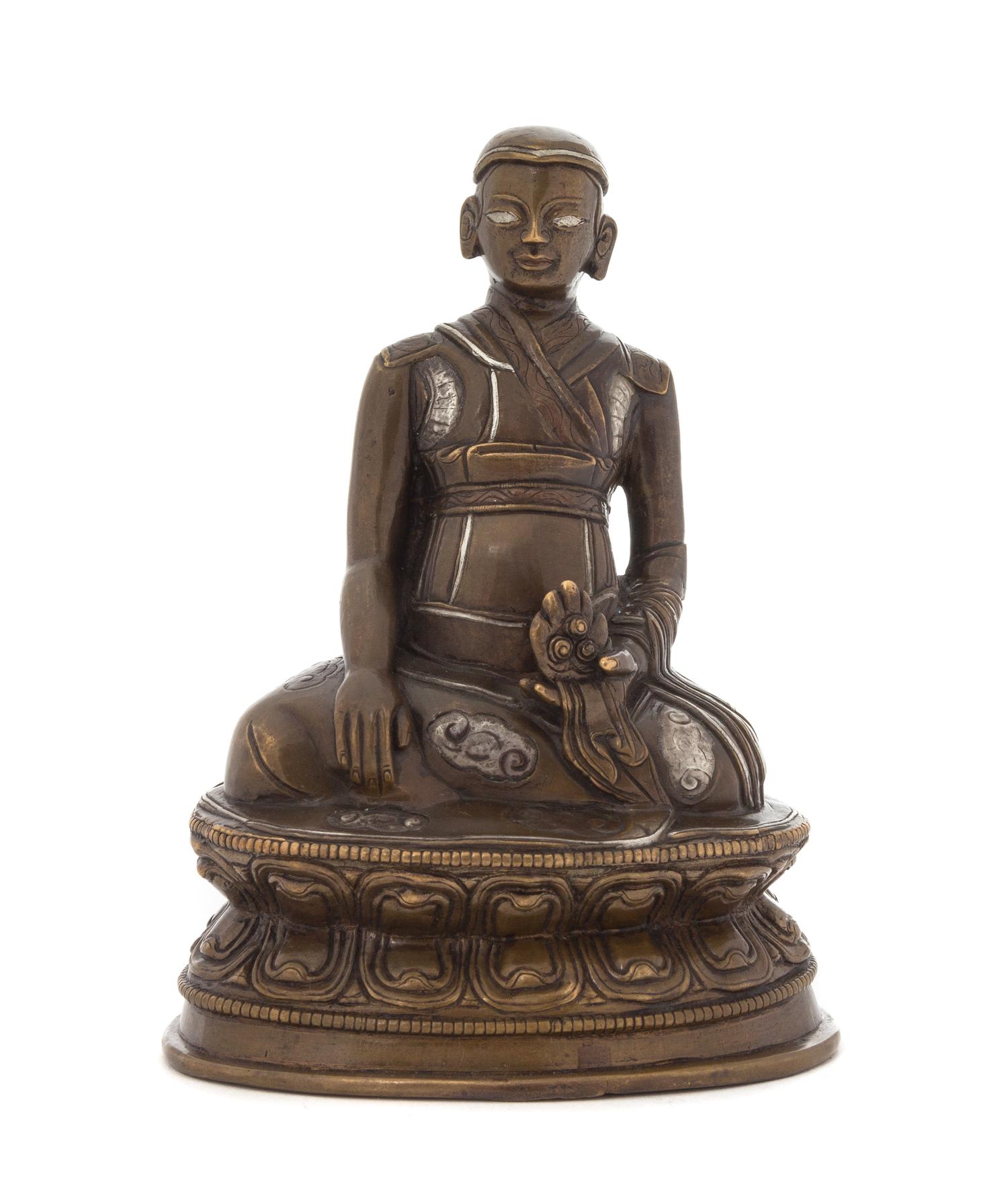 A Tibetan Silver Inlaid Bronze Figure of a Lama