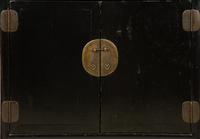 A Chinese Black Lacquer Cabinet with Pierce-carved Upper Door Panels