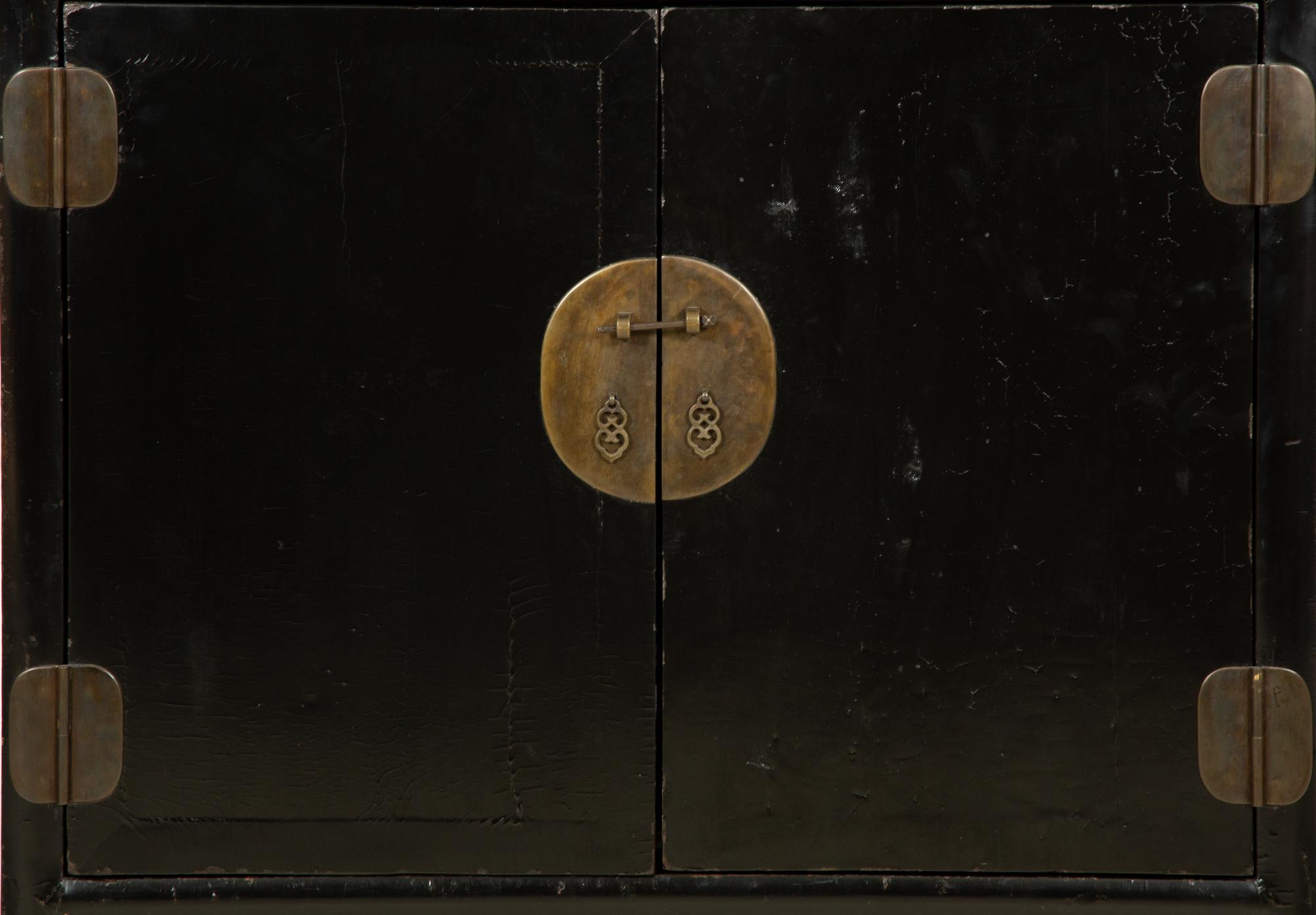 A Chinese Black Lacquer Cabinet with Pierce-carved Upper Door Panels