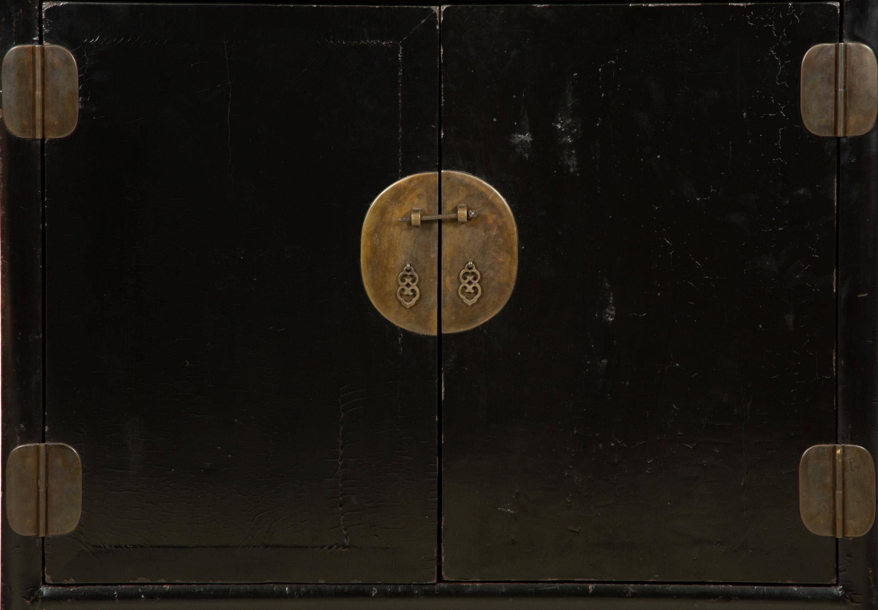 A Chinese Black Lacquer Cabinet with Pierce-carved Upper Door Panels