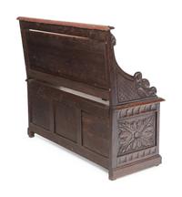 An Italian Renaissance Revival Carved Oak Settle